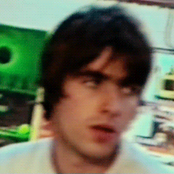 a blurry picture of a young man 's face with a green background