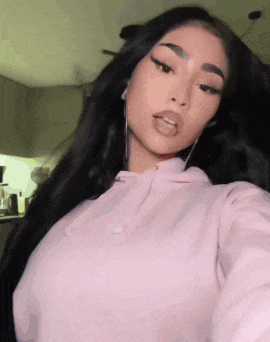 a woman is taking a selfie with her tongue sticking out
