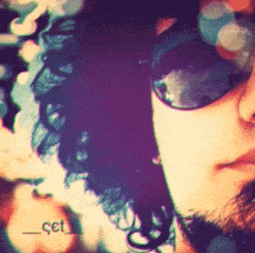 a close up of a man wearing sunglasses and a hat with the letters cet on it