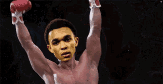a shirtless boxer with his arms in the air ..