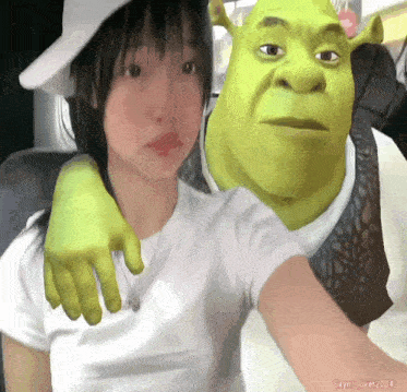 a girl is posing for a picture with shrek in a white hat