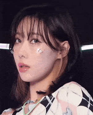 a close up of a woman 's face with a butterfly on her face