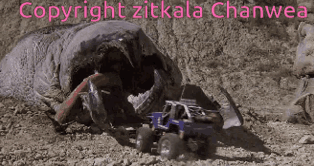 a picture of a monster truck being eaten by a giant worm with copyright zitkala chanwea written on the top