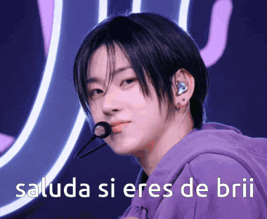 a man in a purple hoodie with a microphone in his mouth and the words saluda si eres de brii