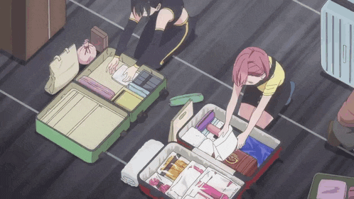 two girls are packing luggage on the floor and one has a pink hair