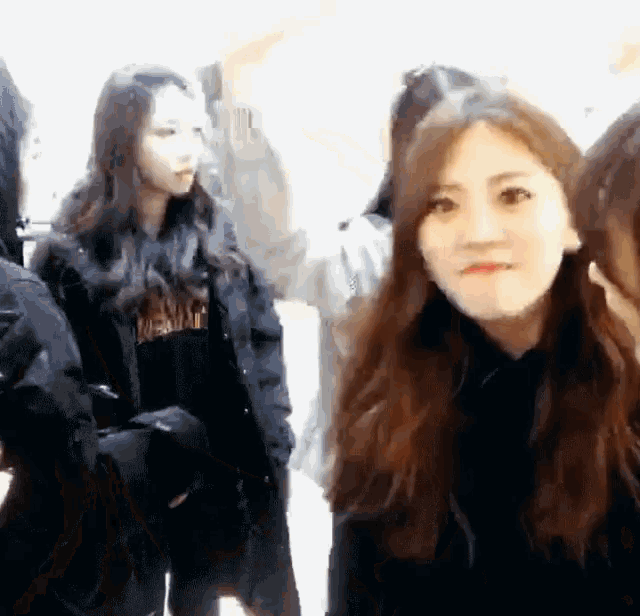 a group of young women are standing in a room and one of them is wearing a black jacket that says ' mermaid '