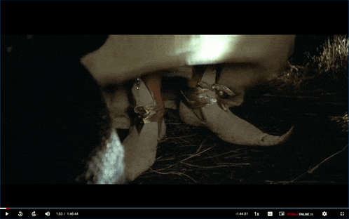 a screenshot of a video shows a person wearing a pair of pointed shoes