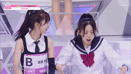 a girl in a sailor suit has the letter b on her shirt