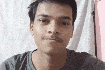 a young man taking a selfie with a pink background
