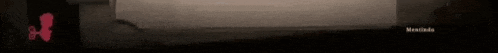 a blurred image of a dark landscape with a pink arrow pointing to the right