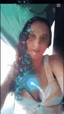 a woman in a bikini takes a selfie in front of an abc sign