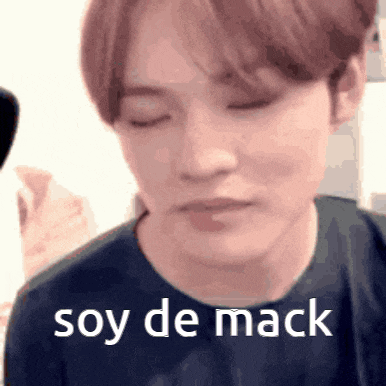 a close up of a person with their eyes closed and the words soy de mack written on their face .