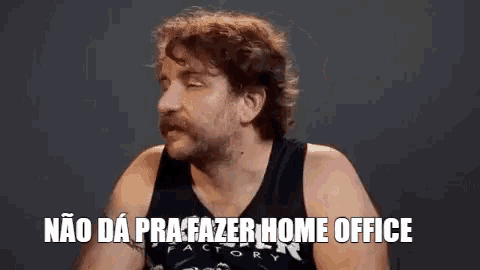 a man with a beard is wearing a black tank top and saying `` não da pra fazer home office '' in portuguese .