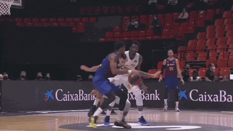 a basketball game is being played in front of a caixabank ad