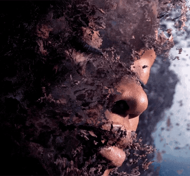 a close up of a person 's face covered in a thick layer of dust