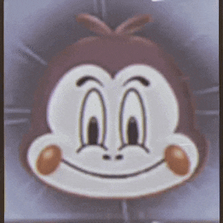 a close up of a monkey 's face with a smile on it 's face .