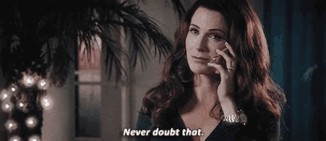 a woman is talking on a cell phone in front of a palm tree .