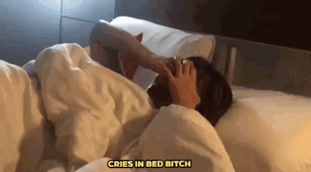 a person is laying in bed with the words cries in bed bitch above them