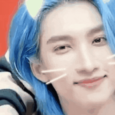 a close up of a person 's face with blue hair and cat ears .