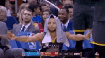 a man is sitting in the stands with his arms outstretched .