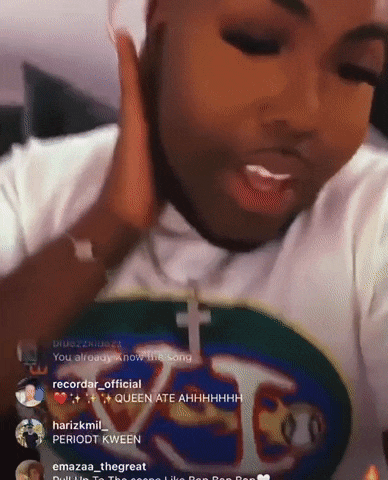 a man wearing a white shirt with a cross on it is talking on a video call .