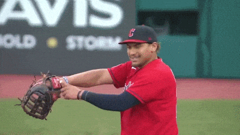 a baseball player wearing a red uniform with the letter c on it