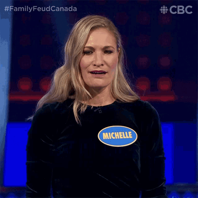 a woman with the name michelle on her shirt is smiling