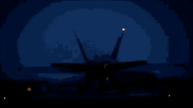 a fighter jet is taking off from a runway at night with its lights on