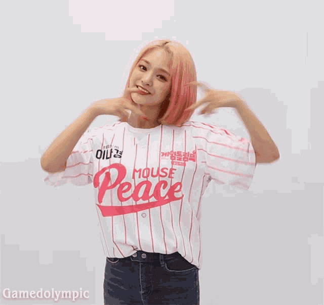a girl with pink hair wears a white and pink striped shirt that says mouse peace