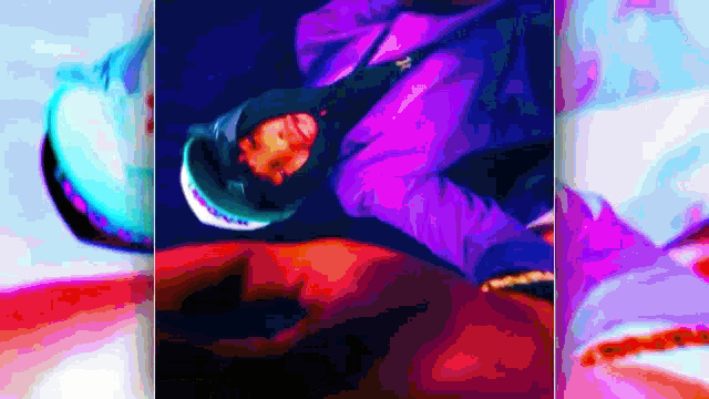a man in a purple jacket is doing a trick in the air