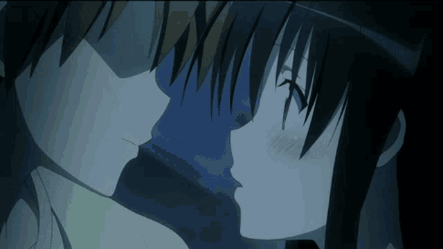 a man and a woman kissing in a dark room