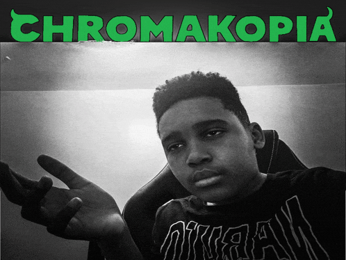 a black and white photo of a young man with chromakopia written on the top