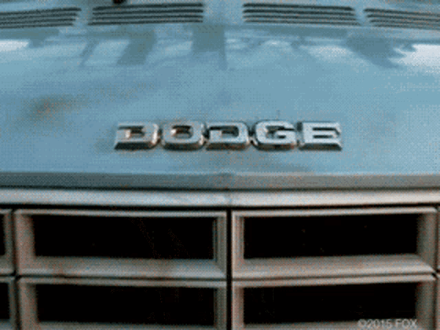 a close up of a dodge emblem on the front of a car