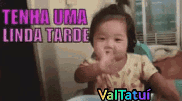 a baby is sitting in a high chair and giving the middle finger .