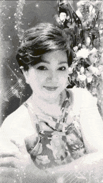 a black and white photo of a woman in a floral shirt