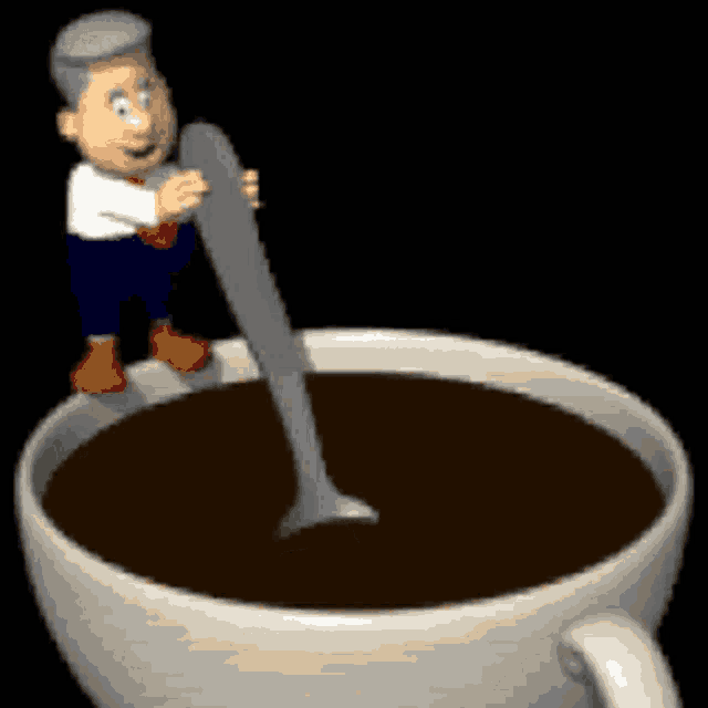 a man is holding a spoon over a cup of coffee
