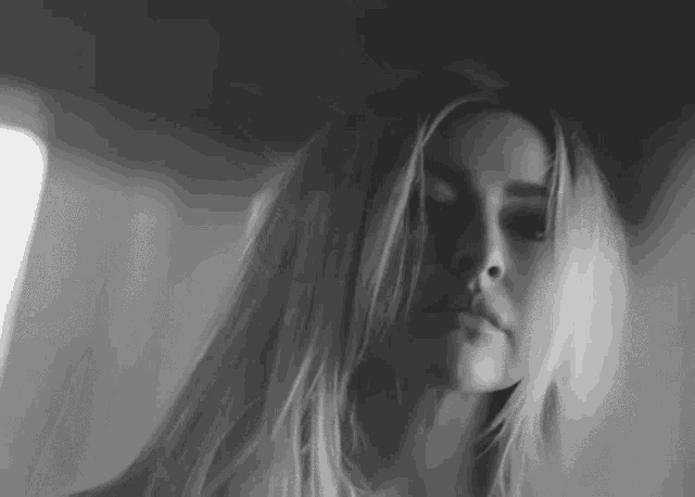 it is a black and white photo of a woman with long blonde hair .