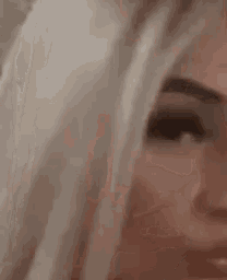 a close up of a woman 's face with her eyes closed and her mouth open .