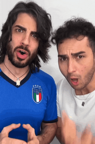 two men are posing for a picture and one of them is wearing an italia shirt