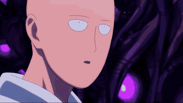 a close up of a bald man 's face with purple lights in the background