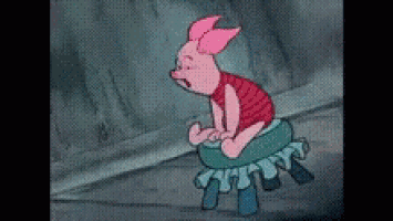 a cartoon piglet is sitting on a green stool .