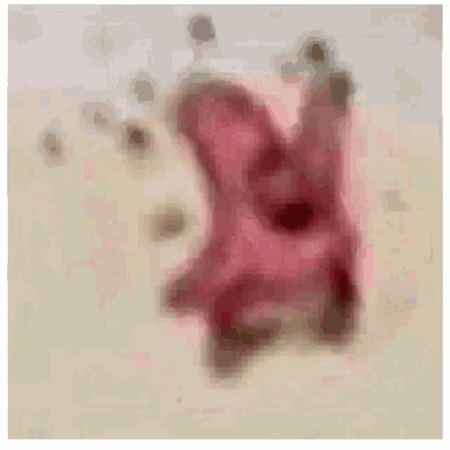 a blurry picture of a pink flower on a sandy surface .