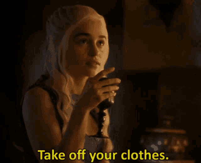 a woman drinking a glass of wine with the words take off your clothes behind her