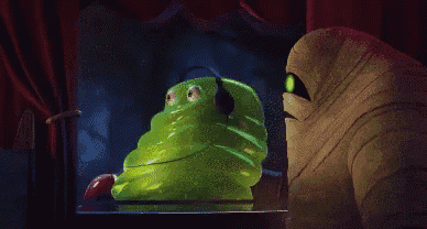 a mummy is looking out a window at a green monster with headphones on