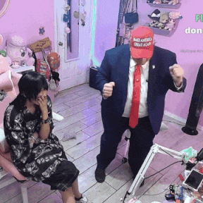 a man in a suit and tie wearing a maga hat