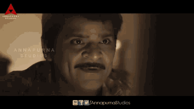 a man with a mustache is on a screen with annapurna studios written on it