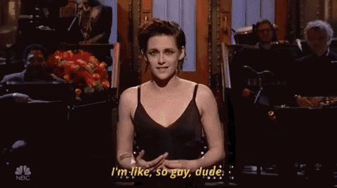 a woman in a black dress says i 'm like so gay dude in front of an orchestra .