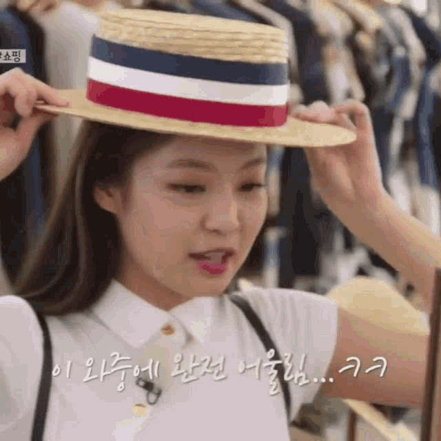 a woman wearing a straw hat with a red white and blue striped band