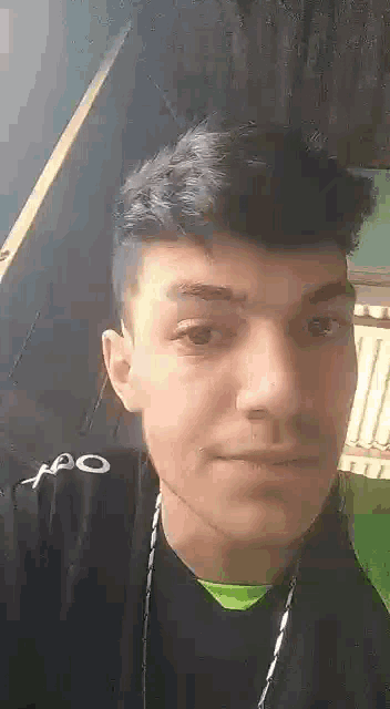 a young man is making a funny face while wearing headphones .