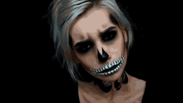 a woman has her face painted to look like a skull